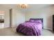 Comfortable bedroom features gray carpet and a purple comforter on the bed at 2608 Prospector Mine Ave, North Las Vegas, NV 89031