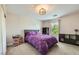 Bright bedroom featuring gray carpet, natural light, and purple comforter at 2608 Prospector Mine Ave, North Las Vegas, NV 89031
