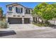 Beautiful two-story home boasts a tile roof, two-car garage, and manicured landscaping at 2608 Prospector Mine Ave, North Las Vegas, NV 89031