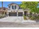 Charming two-story home featuring a three-car garage, stone accents, and a well-maintained front yard at 2608 Prospector Mine Ave, North Las Vegas, NV 89031