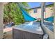 Backyard featuring a hot tub partially shaded by trees and a canvas shade at 2608 Prospector Mine Ave, North Las Vegas, NV 89031