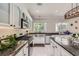 Modern kitchen featuring marble floors, granite countertops, white cabinets and stainless steel appliances at 2608 Prospector Mine Ave, North Las Vegas, NV 89031