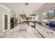 Modern kitchen featuring marble floors, white cabinets, stainless steel appliances, and a center island at 2608 Prospector Mine Ave, North Las Vegas, NV 89031