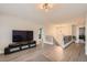 Open-concept living room with modern lighting, luxury vinyl flooring and a wrought iron staircase at 2608 Prospector Mine Ave, North Las Vegas, NV 89031