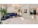 Open-concept living room with marble floors, contemporary light fixture and comfortable seating at 2608 Prospector Mine Ave, North Las Vegas, NV 89031