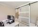 Bright home office featuring a frosted glass barn door, modern desk setup, and lots of natural light at 2608 Prospector Mine Ave, North Las Vegas, NV 89031