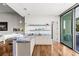Modern bar area featuring granite countertops, white cabinets, and glass doors to the backyard at 2610 Eldora Estates Ct, Las Vegas, NV 89117