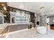 Spacious bathroom with a soaking tub, walk-in glass shower, marble countertops, and large mirrors at 2610 Eldora Estates Ct, Las Vegas, NV 89117