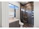 Modern bathroom features a glass shower, gray vanity, and sleek fixtures at 2610 Eldora Estates Ct, Las Vegas, NV 89117
