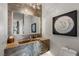 Stylish powder room featuring unique stone vanity, eye-catching mirror, and modern lighting at 2610 Eldora Estates Ct, Las Vegas, NV 89117