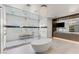 Contemporary bathroom with a soaking tub, a walk-in glass shower and marble countertops at 2610 Eldora Estates Ct, Las Vegas, NV 89117