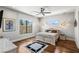 Comfortable bedroom with hardwood floors, large windows, and modern lighting at 2610 Eldora Estates Ct, Las Vegas, NV 89117