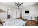 Bedroom features hardwood floors, a ceiling fan and access to an ensuite bathroom at 2610 Eldora Estates Ct, Las Vegas, NV 89117