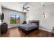 Bedroom showcasing hardwood floors, a ceiling fan, and a window with a backyard view at 2610 Eldora Estates Ct, Las Vegas, NV 89117