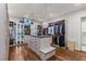 Large walk-in closet with custom shelving, drawers, an island, and hardwood floors at 2610 Eldora Estates Ct, Las Vegas, NV 89117