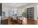 Contemporary dining room featuring stylish decor, built-in display cabinet, and access to outdoor views at 2610 Eldora Estates Ct, Las Vegas, NV 89117
