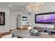 Open-concept dining room with modern furnishings, stylish lighting, and seamless flow to living area at 2610 Eldora Estates Ct, Las Vegas, NV 89117