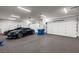 Spacious three-car garage with epoxy floors and ample storage space at 2610 Eldora Estates Ct, Las Vegas, NV 89117