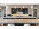 Modern kitchen featuring a large island with marble countertop, stylish cabinetry, and pendant lighting at 2610 Eldora Estates Ct, Las Vegas, NV 89117
