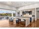 Modern kitchen featuring a large island, sleek cabinetry, and an open patio with comfortable seating at 2610 Eldora Estates Ct, Las Vegas, NV 89117