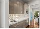 Modern kitchen with stainless steel sink, designer backsplash, and sleek cabinets, and butler's pantry at 2610 Eldora Estates Ct, Las Vegas, NV 89117