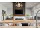 Open kitchen view of the modern fireplace, living room, baby grand piano and a glimpse of the bar at 2610 Eldora Estates Ct, Las Vegas, NV 89117