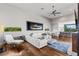Open concept living room with hardwood flooring, white leather couch, and access to a gourmet kitchen at 2610 Eldora Estates Ct, Las Vegas, NV 89117