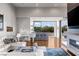 Modern open floor plan with large glass doors, bar seating, and white baby grand piano at 2610 Eldora Estates Ct, Las Vegas, NV 89117