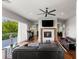 Bright living room featuring a fireplace, hardwood floors, comfortable leather seating and sliding glass doors to the backyard at 2610 Eldora Estates Ct, Las Vegas, NV 89117