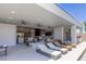 Spacious outdoor living area with modern lounge furniture, ceiling fans, and access to the home's interior at 2610 Eldora Estates Ct, Las Vegas, NV 89117