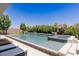Beautiful backyard pool and spa with lush landscaping and relaxing lounge chairs at 2610 Eldora Estates Ct, Las Vegas, NV 89117