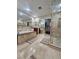 Luxurious bathroom featuring a large soaking tub with tile surround, dual vanities, a shower, and a walk-in closet at 2913 Domino Way, Las Vegas, NV 89117