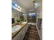 Bathroom featuring double sinks with granite counters, wood floors, and a shower tub combo at 2913 Domino Way, Las Vegas, NV 89117