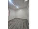 Bright bedroom with modern gray flooring, a neutral color scheme, and ample closet space for storage at 2913 Domino Way, Las Vegas, NV 89117