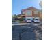 Two-story house with neutral tones, red roof, three-car garage, and desert landscaping at 2913 Domino Way, Las Vegas, NV 89117
