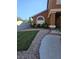 Charming home features a welcoming front yard with lush green grass, rock accents, and a well-maintained landscape at 2913 Domino Way, Las Vegas, NV 89117