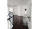 Upstairs hallway with wood flooring, white doors, and a decorative glass table and mirror at 2913 Domino Way, Las Vegas, NV 89117
