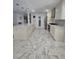Modern kitchen with marble tile flooring, white cabinetry, and a large island at 2913 Domino Way, Las Vegas, NV 89117