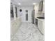 Bright kitchen featuring marble tile flooring, pantry, white cabinets, and stainless steel appliances at 2913 Domino Way, Las Vegas, NV 89117