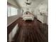 Spacious main bedroom featuring hardwood floors, two dressers, a ceiling fan, and a king-size bed with bench at 2913 Domino Way, Las Vegas, NV 89117