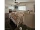 Main bedroom with ceiling fan and dark laminate floors and a large window providing natural light at 2913 Domino Way, Las Vegas, NV 89117