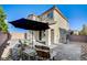 Exterior view of the home showcasing a private patio area, lush plants and privacy wall at 3002 Coveri Ct, Las Vegas, NV 89141