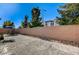 View of the backyard with a concrete patio and exterior perimeter wall at 3002 Coveri Ct, Las Vegas, NV 89141