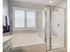 Bright bathroom showcasing a tub/shower combo with white subway tile and plantation shutters at 3002 Coveri Ct, Las Vegas, NV 89141