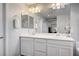 Bright bathroom featuring double sinks and a large mirror with modern lighting above white cabinetry at 3002 Coveri Ct, Las Vegas, NV 89141