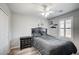 Modern bedroom with ceiling fan, wood-look floors, and window with shutters, for a relaxing atmosphere at 3002 Coveri Ct, Las Vegas, NV 89141