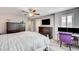 Comfortable bedroom featuring wood-look floors, a ceiling fan, and a workstation with dual monitors at 3002 Coveri Ct, Las Vegas, NV 89141