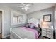 Cozy bedroom with white furniture, ceiling fan, and a stylish mirror above the bed at 3002 Coveri Ct, Las Vegas, NV 89141