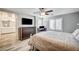 Primary bedroom with a queen bed, shutters on the windows, ceiling fan, and a view of the ensuite at 3002 Coveri Ct, Las Vegas, NV 89141