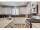 Modern kitchen featuring stainless steel appliances, granite countertops, and ample cabinet space at 3002 Coveri Ct, Las Vegas, NV 89141